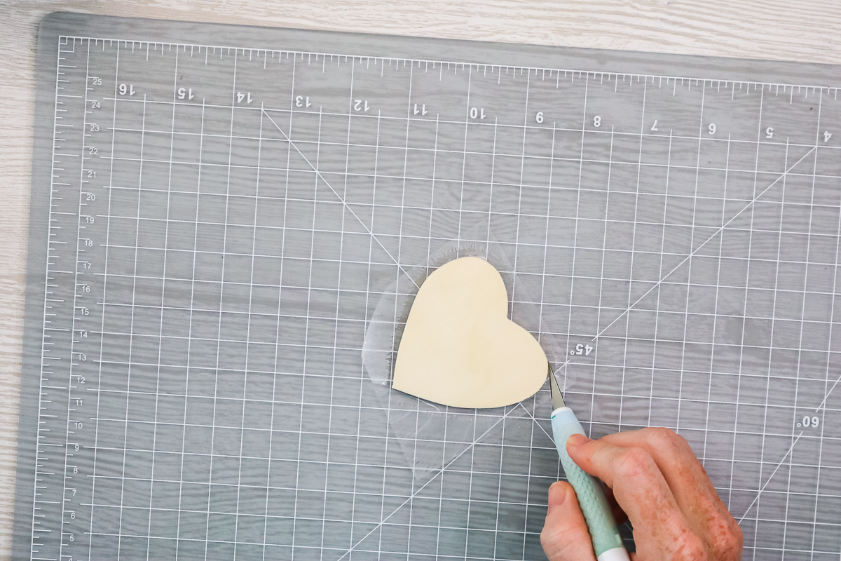 cutting away lamination sheet from wood heart