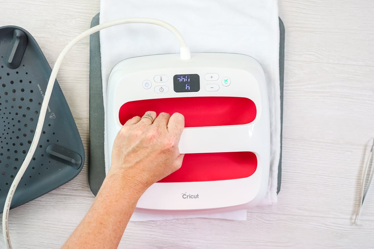 cricut easypress pressing a tea towel with infusible ink