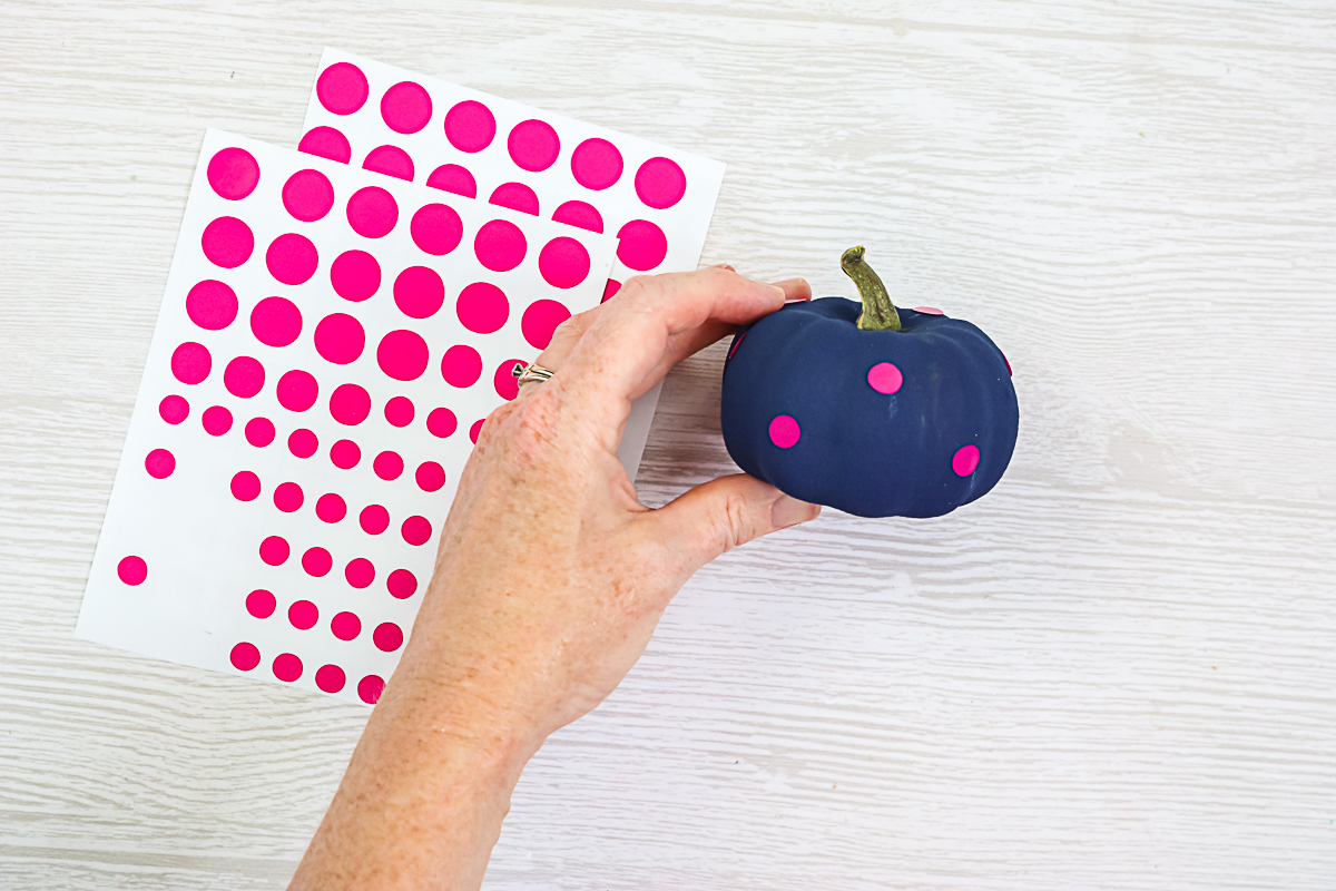 adding cut vinyl to painted pumpkins