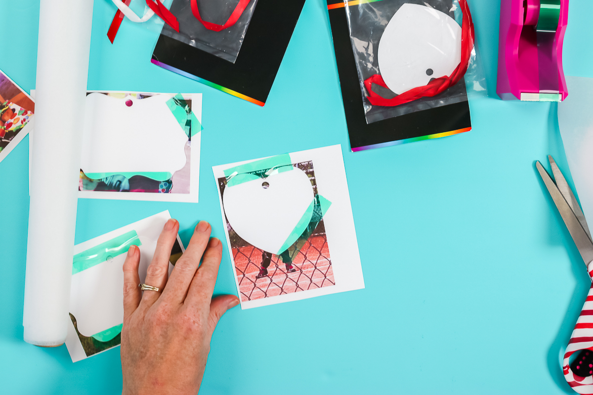 taping sublimation print in place on a christmas ornament