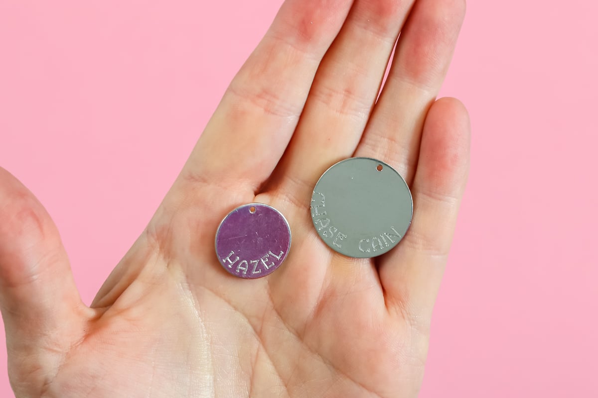 names engraved on round metal pieces