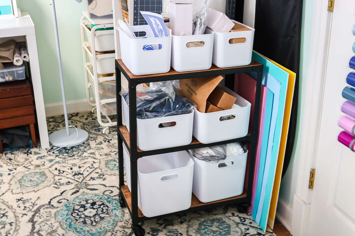 plastic bins on a cart in a craft room