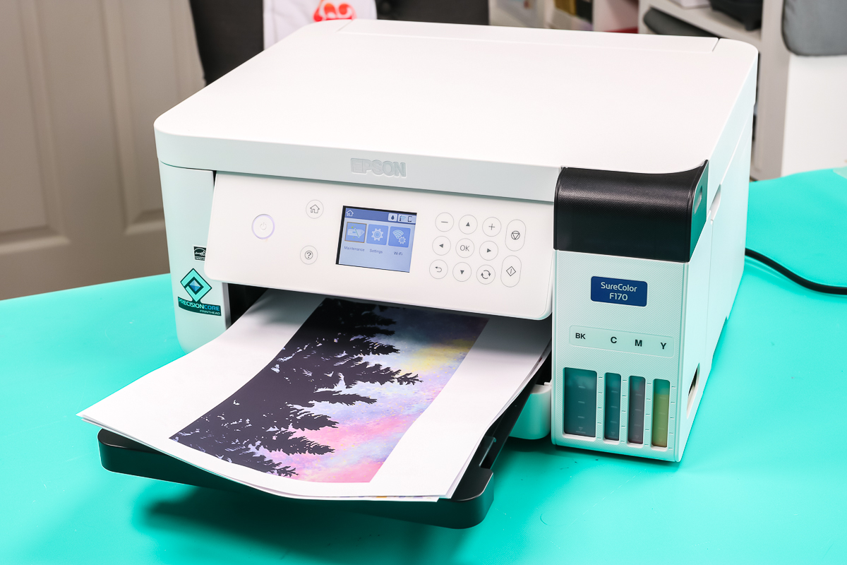 Epson SureColor F170 Sublimation Printer with sublimation prints printed out in the tray.