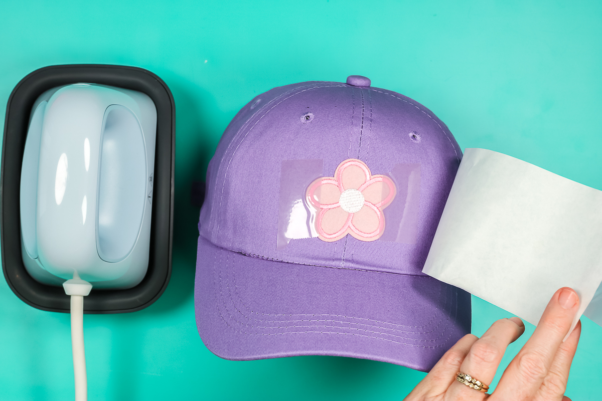 Remove butcher paper to check embroidered patch on hat.