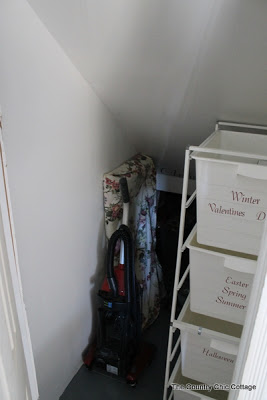 Closet organization open space with vacuum and table leaf.