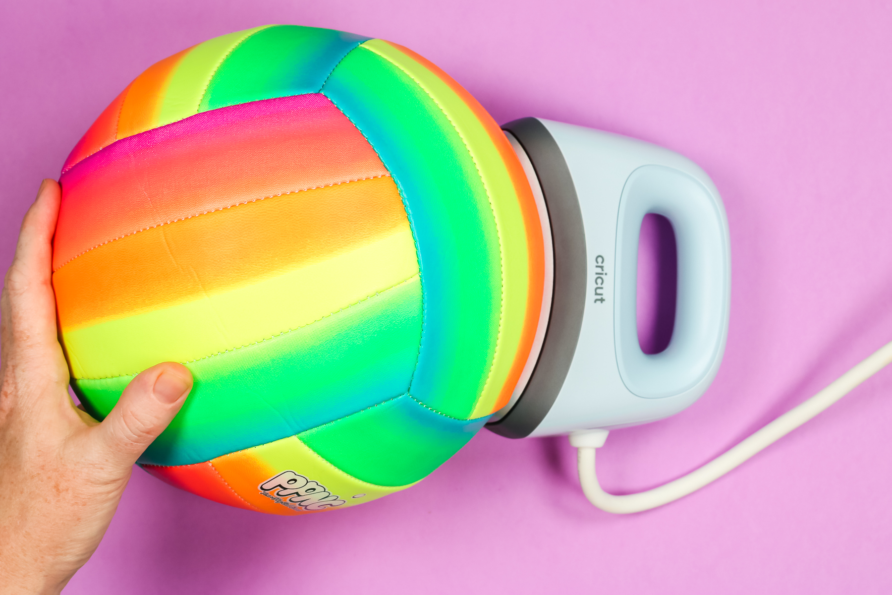 Rainbow volleyball with Cricut Hat Press showing the curve fits perfectly.