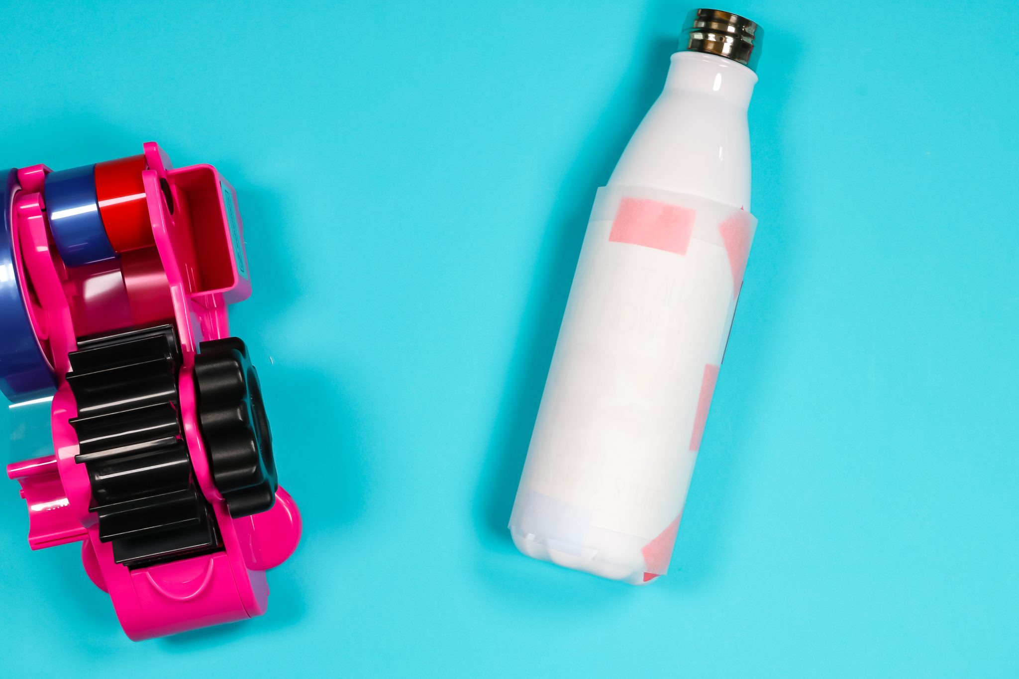 Protective paper taped to tapered water bottle.