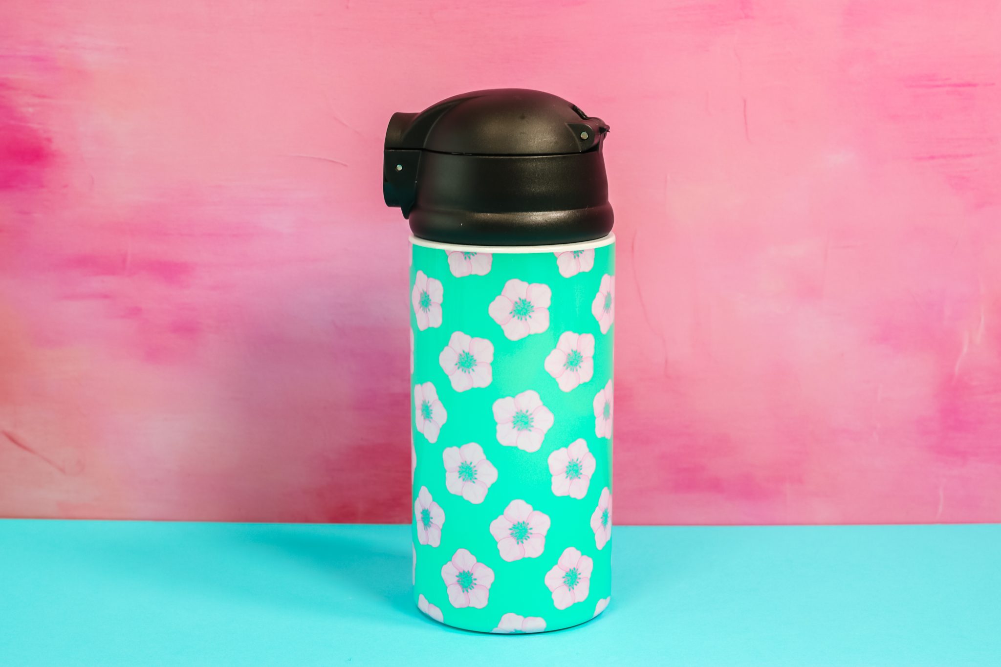 Sublimated water bottle with flower-filled wrapper.