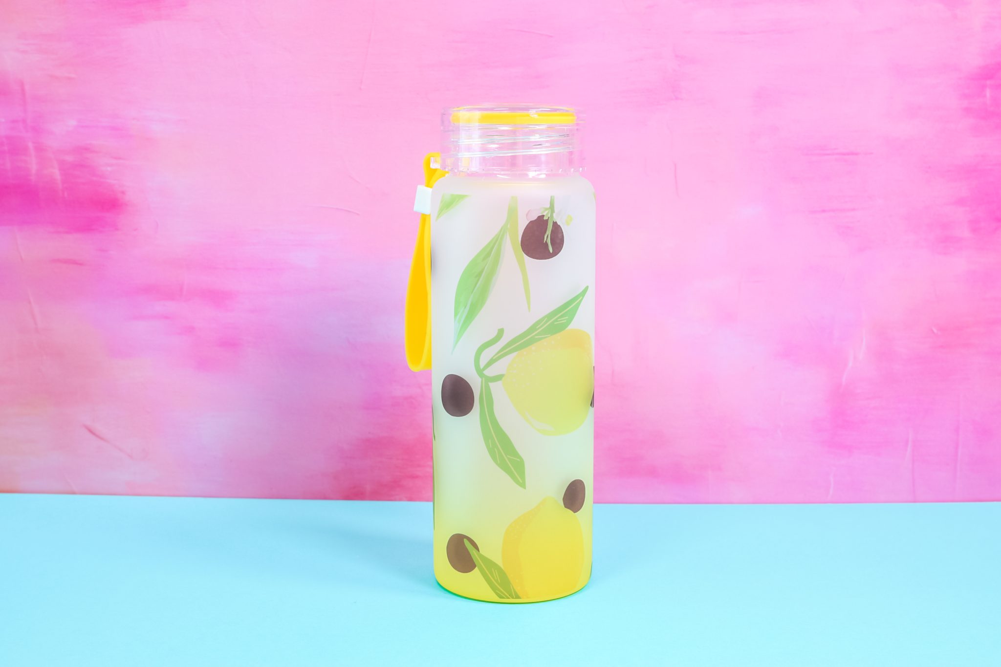 Sublimated glass water bottle with lemon print.