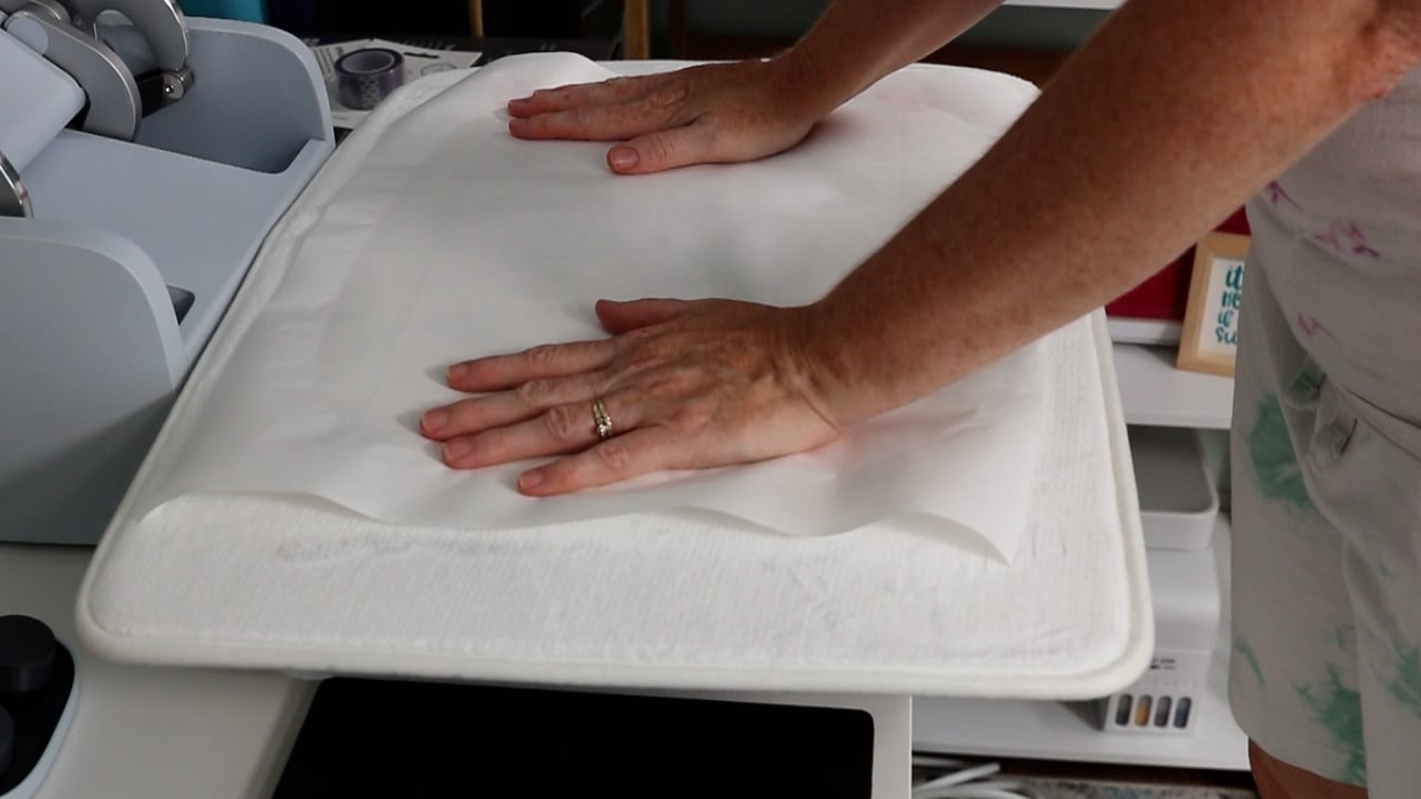 Add protective paper to the top of sublimation design.