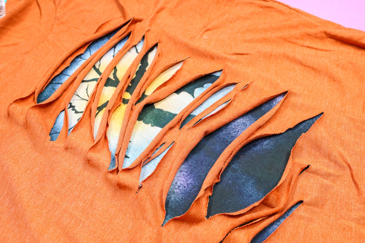 Orange Halloween sublimation peek-a-boo shirt.