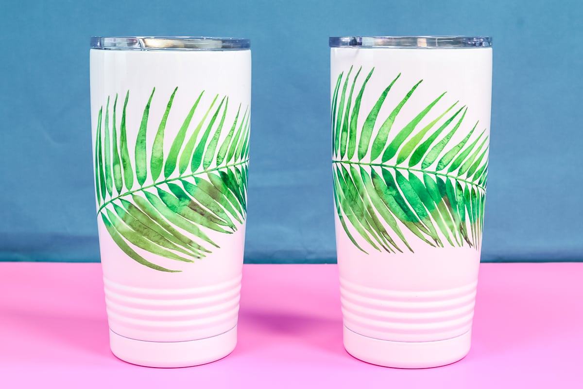 White tumblers with sublimation watercolor palm leaves.