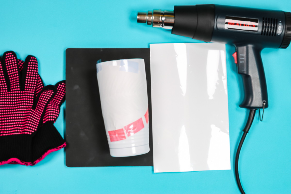 Sublimation tumbler with shrink wrap sleeve and heat gun.
