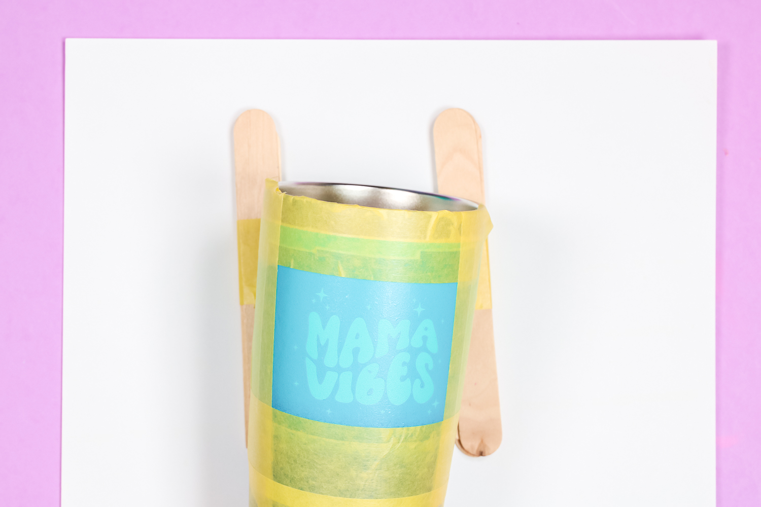 Stencil vinyl on tumbler with popsicle sticks to hold it in place.