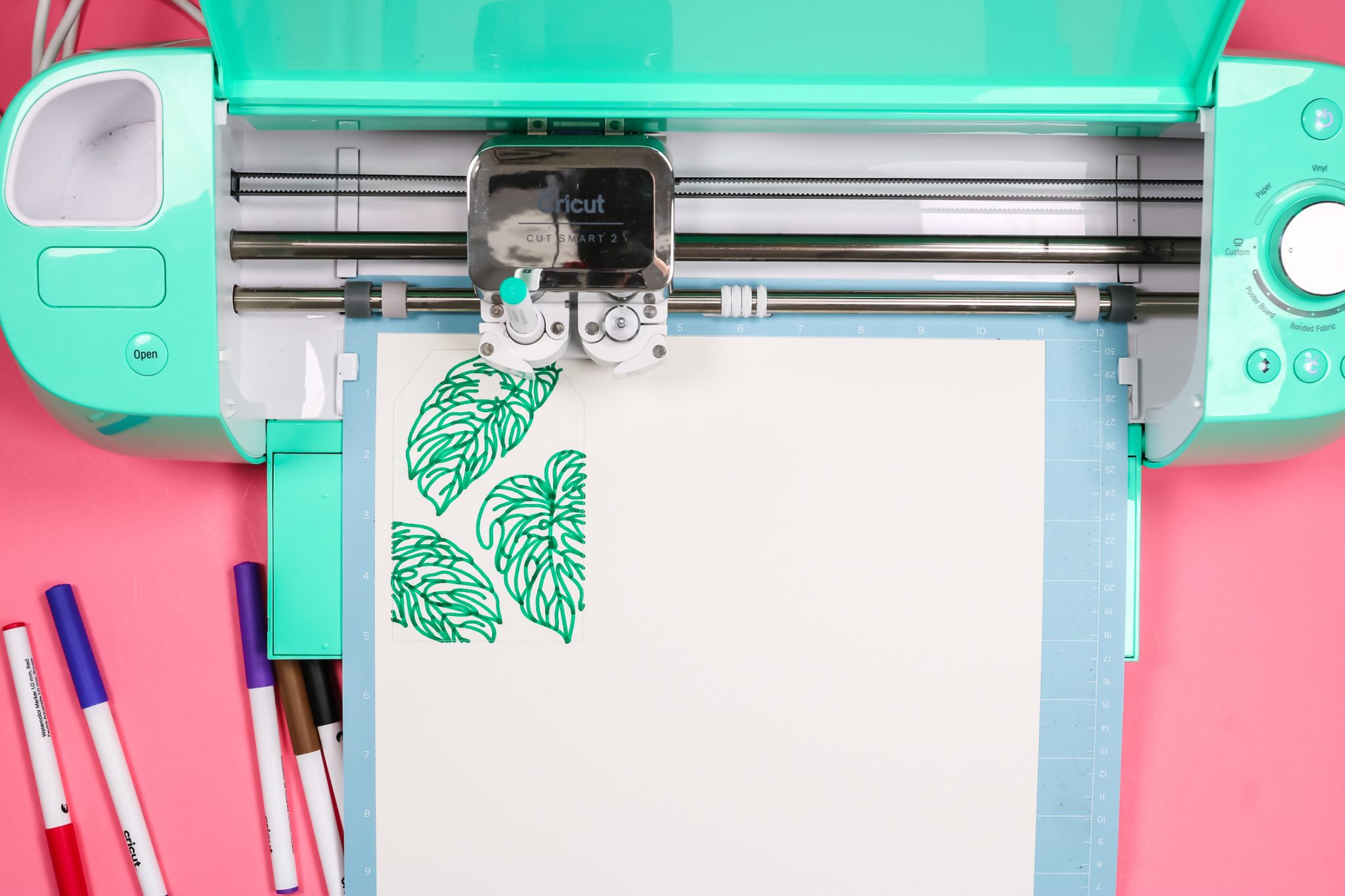 Cricut machine drawing leaves with watercolor marker.