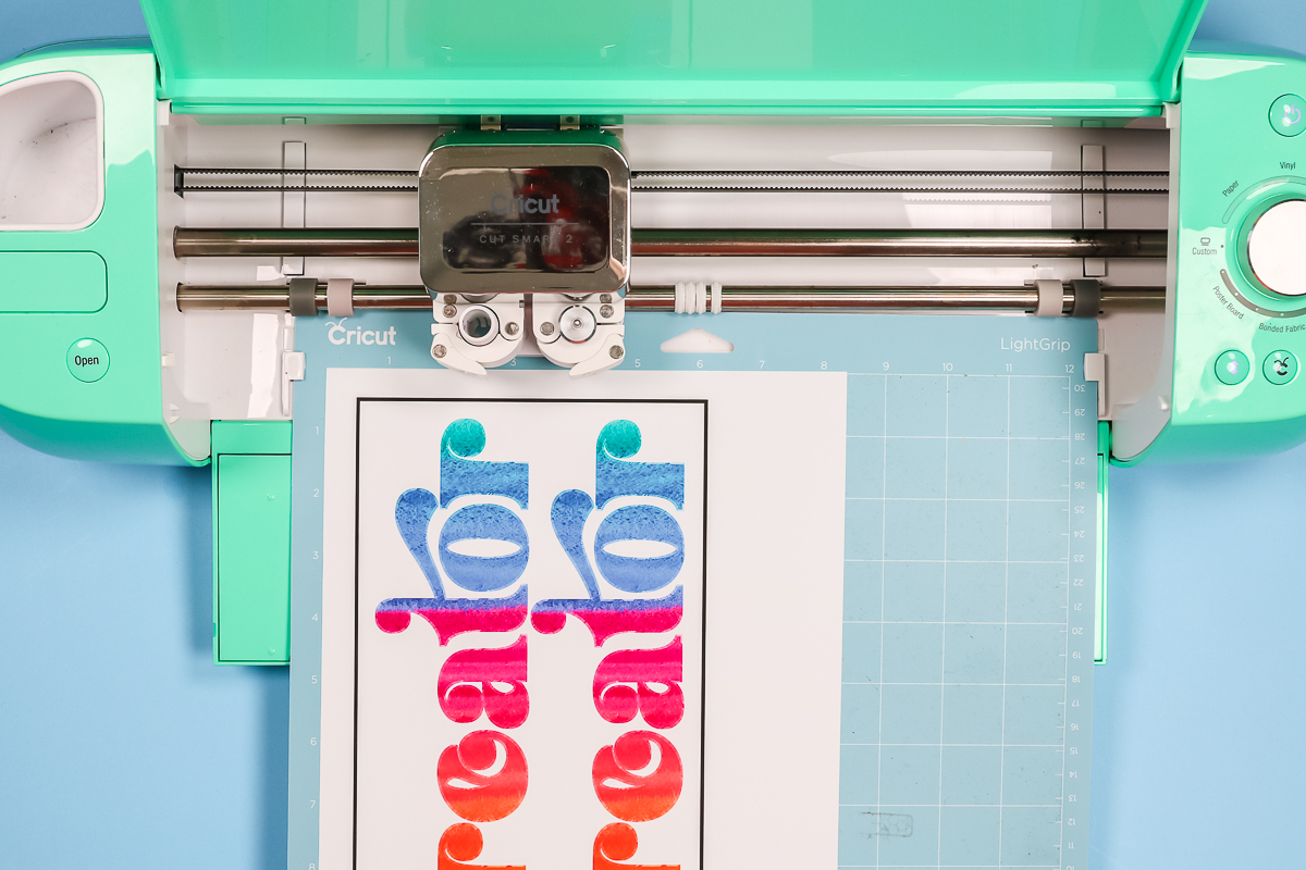 Cricut machine cutting print then cut image.