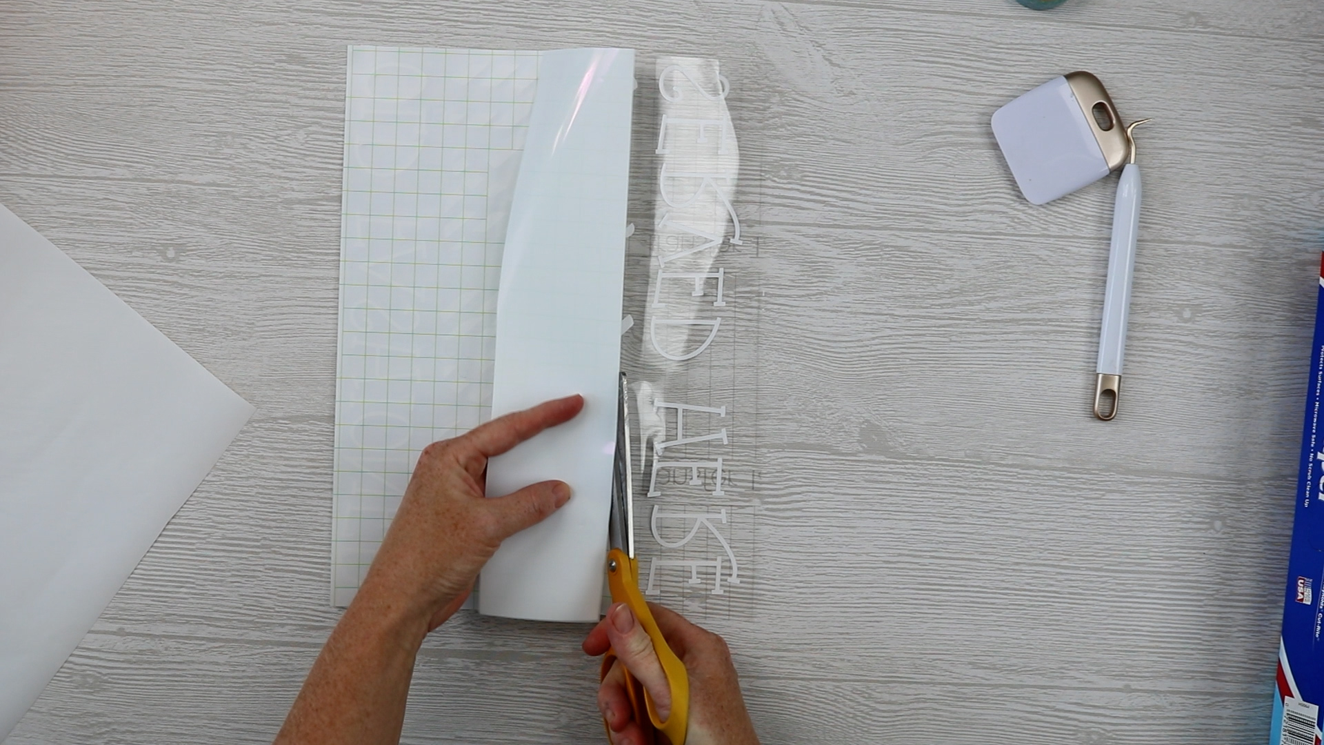 removing a portion of the backing paper