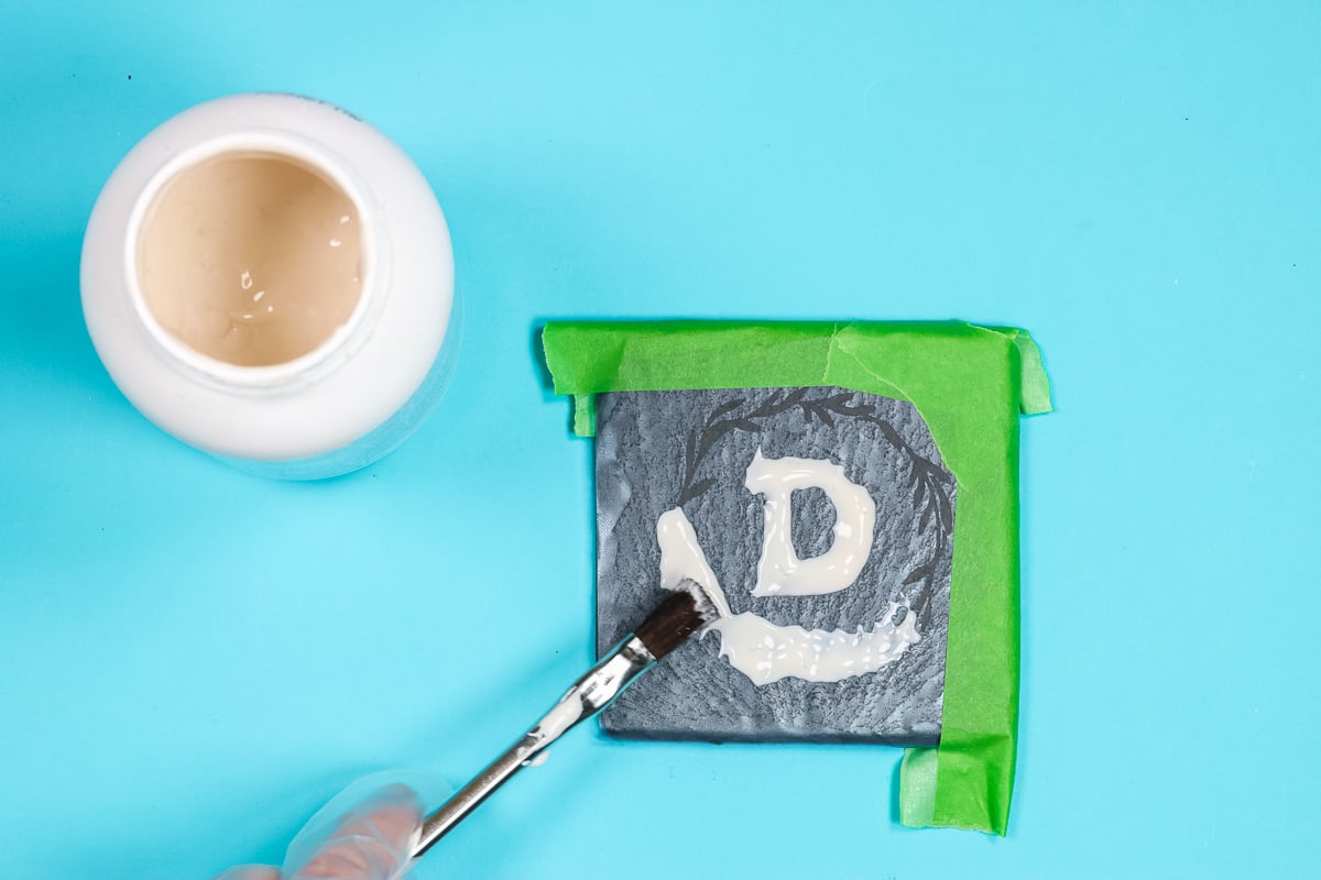 Apply etching cream to slate with a paint brush.