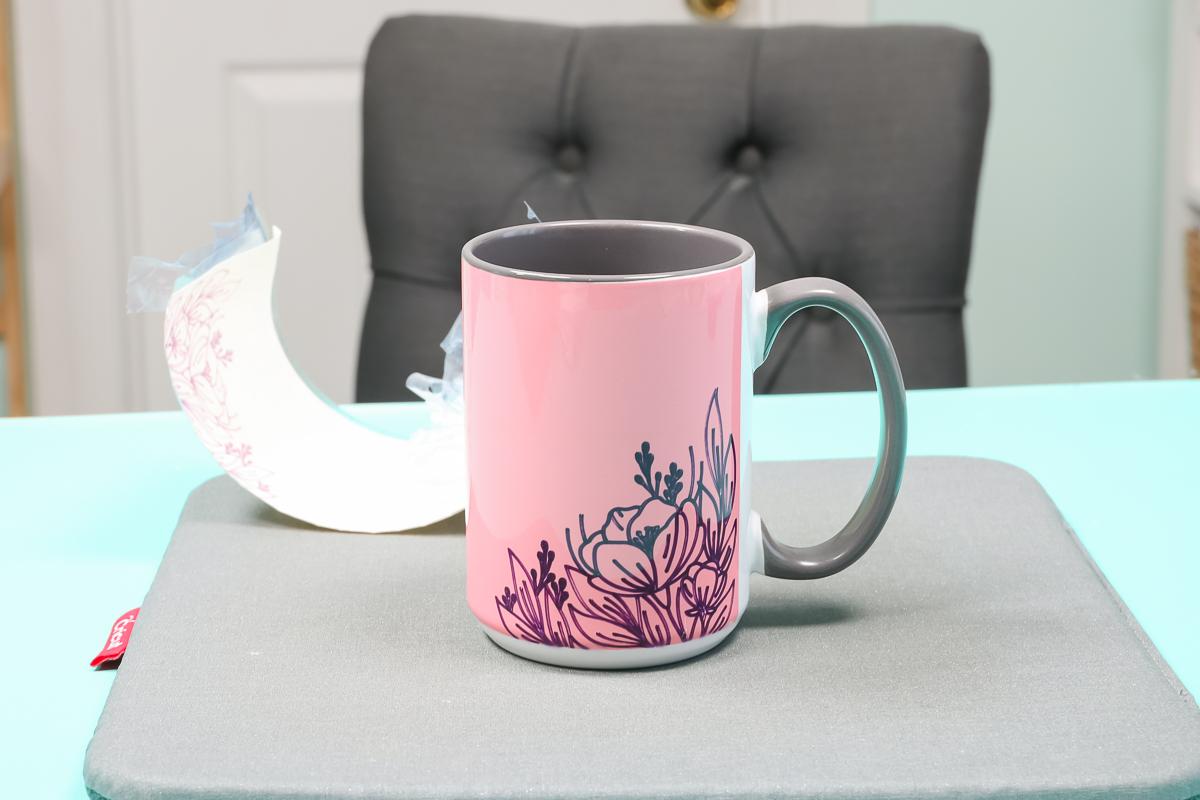 Remove layered Cricut Infusible Ink sheet from mug.