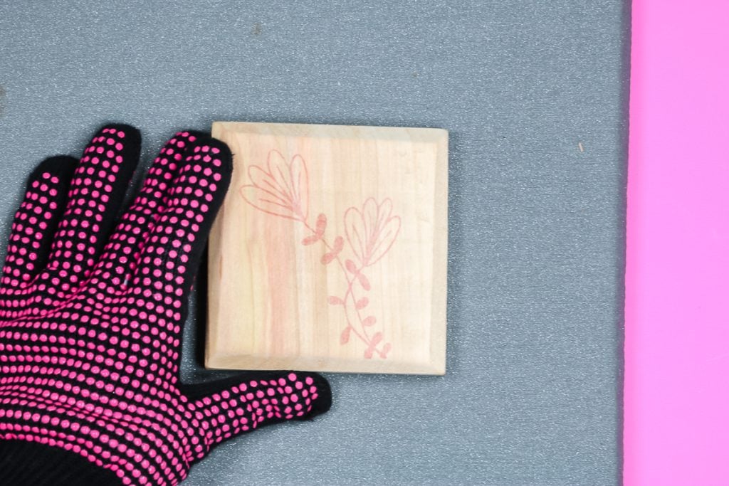 Heat-resistant glove and mat with wood block.