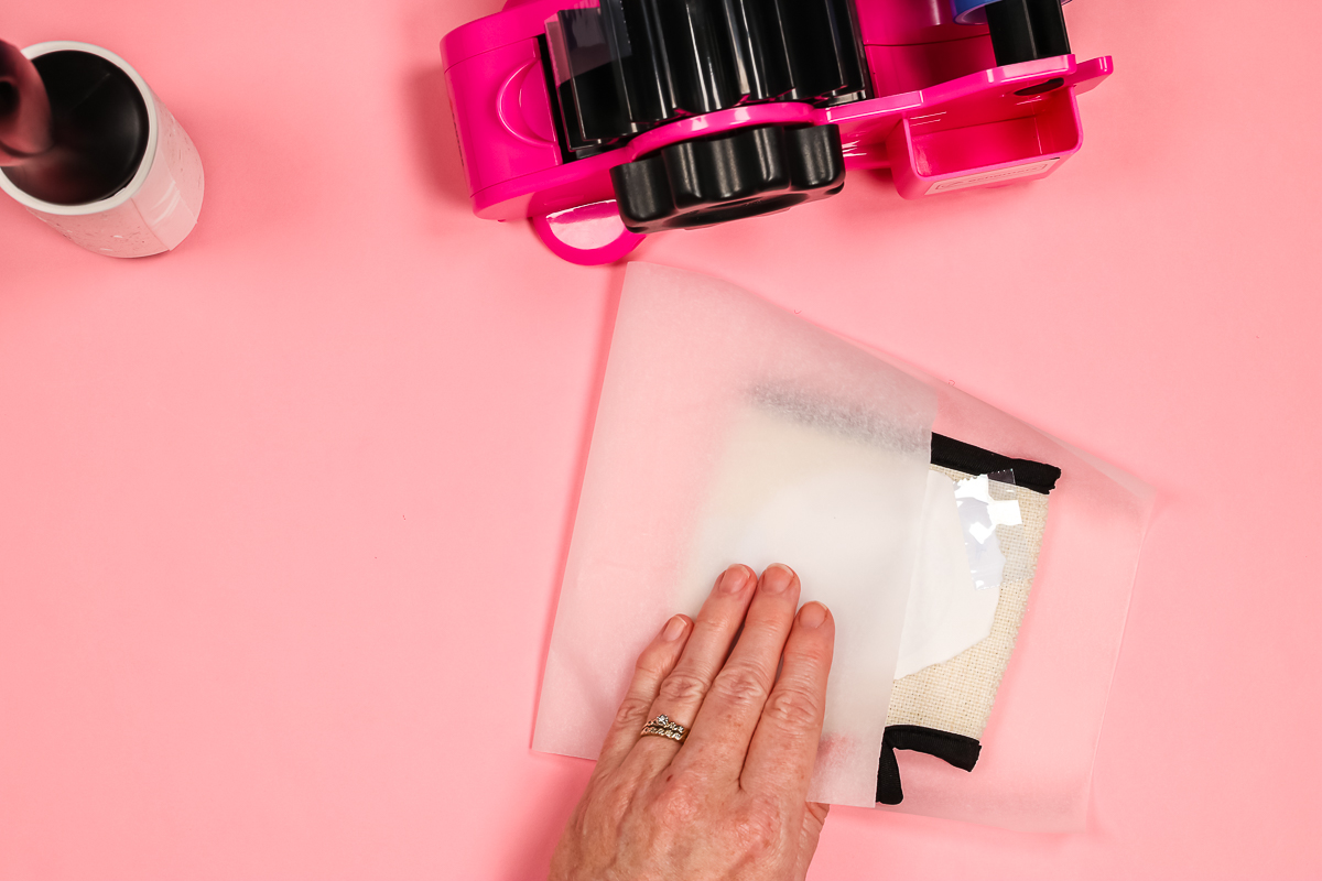 Adding protective paper around sublimation koozie.