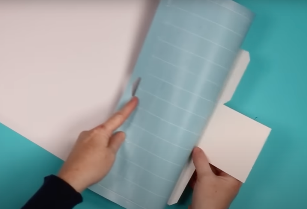 Roll the cutting mat away from cut paper.
