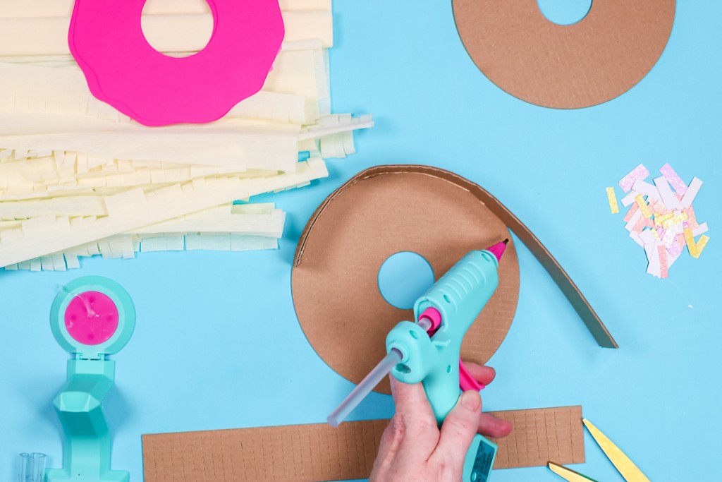 Hot glue rectangle strips to donut circles.