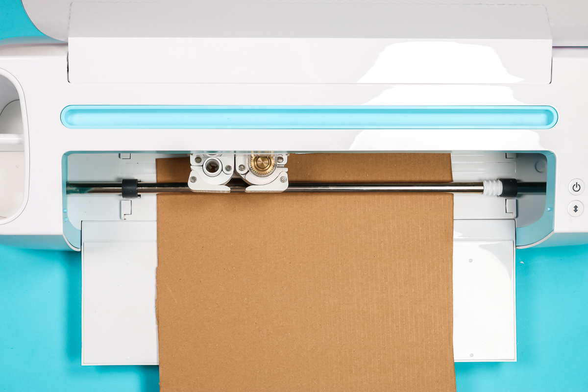 Make sure cardboard fits under the roller bar on the Cricut machine.