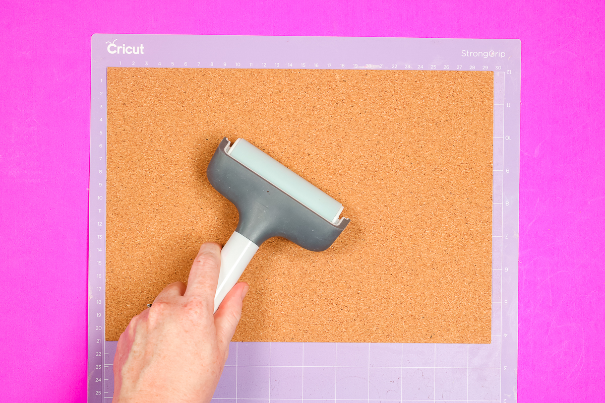 Apply cork to a StrongGrip mat with a brayer.