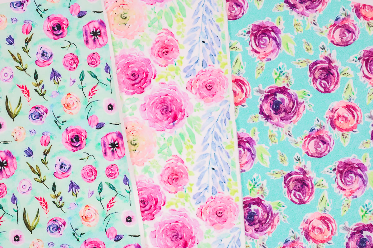 Different floral sublimation designs on white faux leather.
