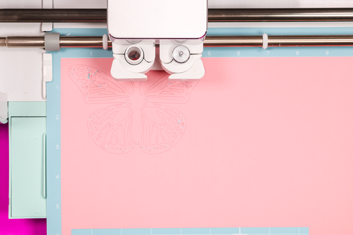 Light pink cardstock loaded in Cricut machine.