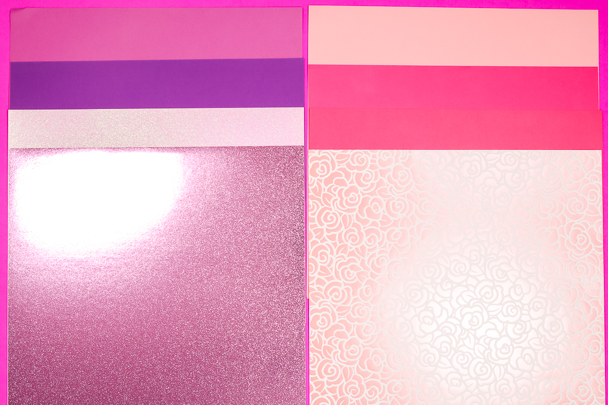 Different types of cardstock in pinks and purples.