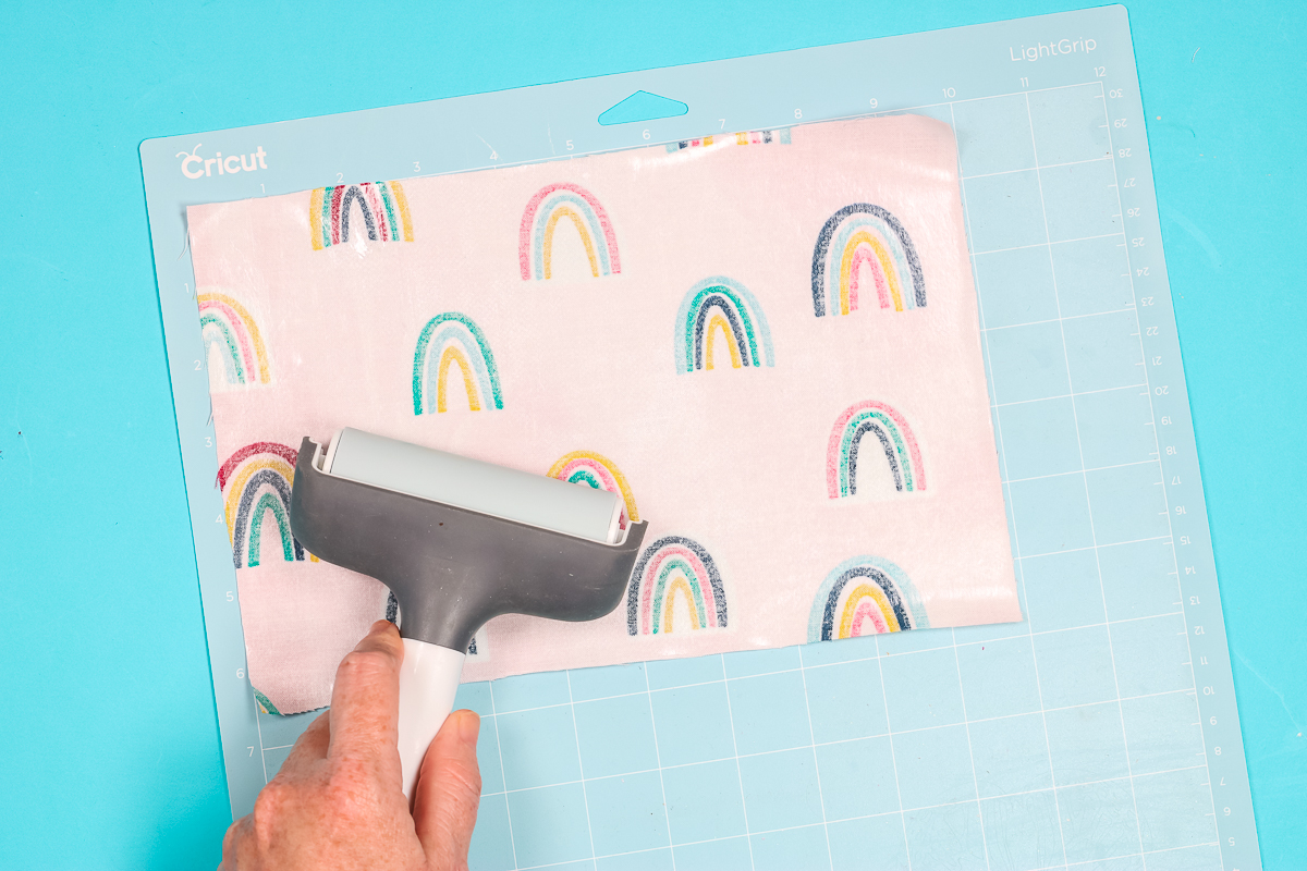 Use brayer to adhere fabric to cutting mat.