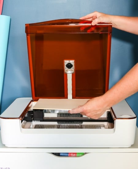 angie holden adding material to a glowforge aura