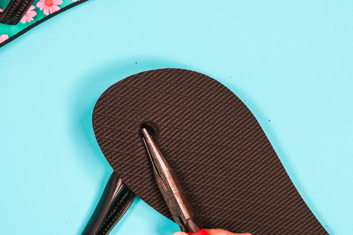 Use pliers to flatten the bottom of the toe strap.