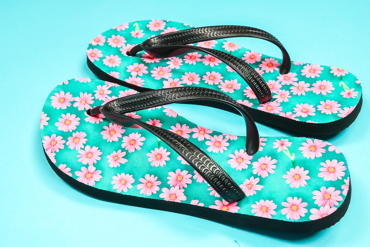 Close up of finished pink daisy flip flops.