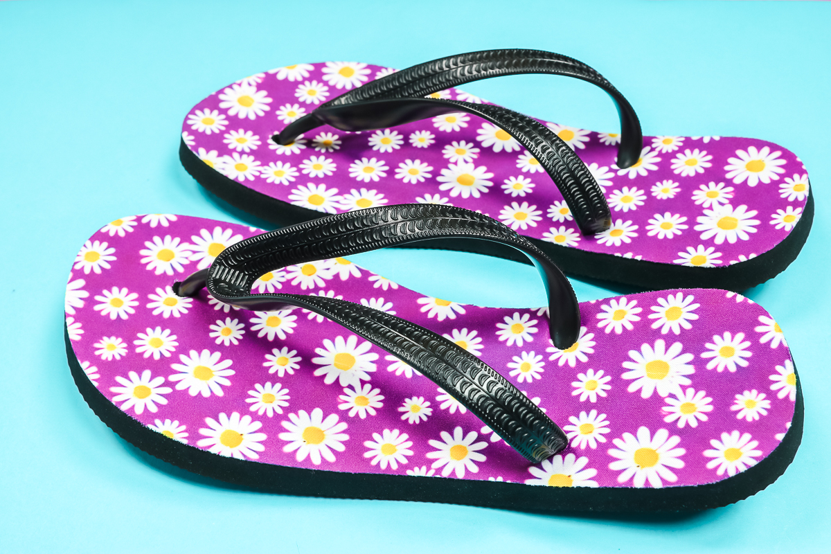 Close up of purple flip flops.