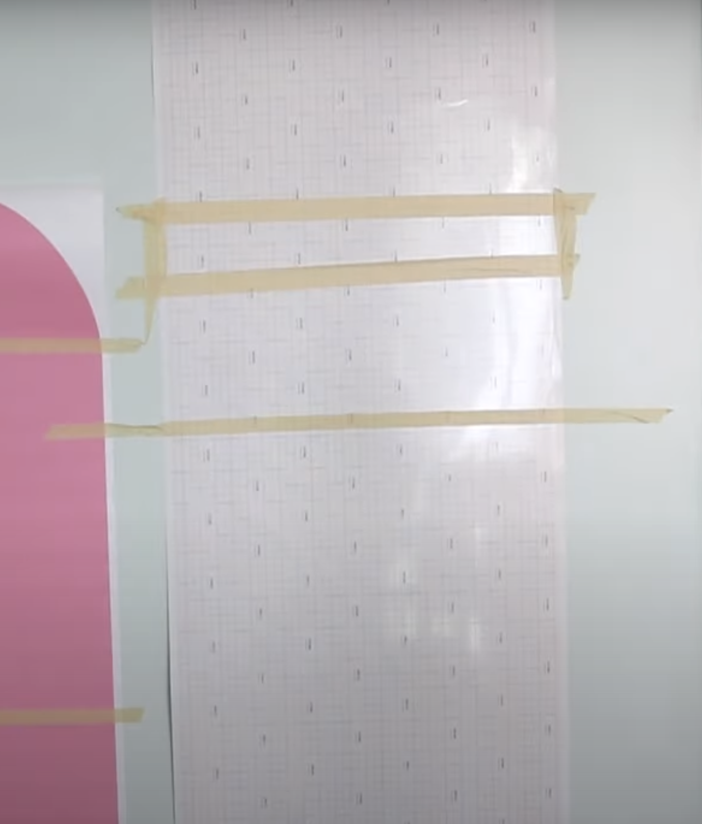 Use painter's tape to hold decal on wall.