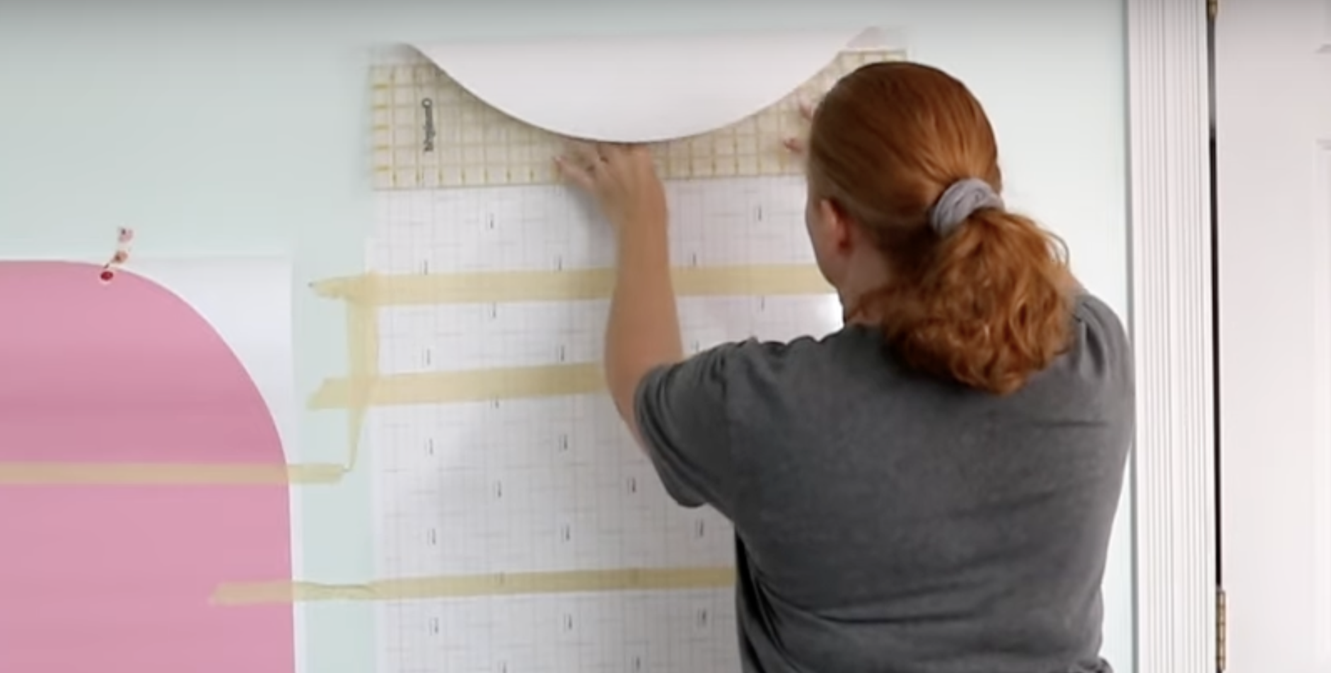 Use quilting ruler to smooth decal onto wall.