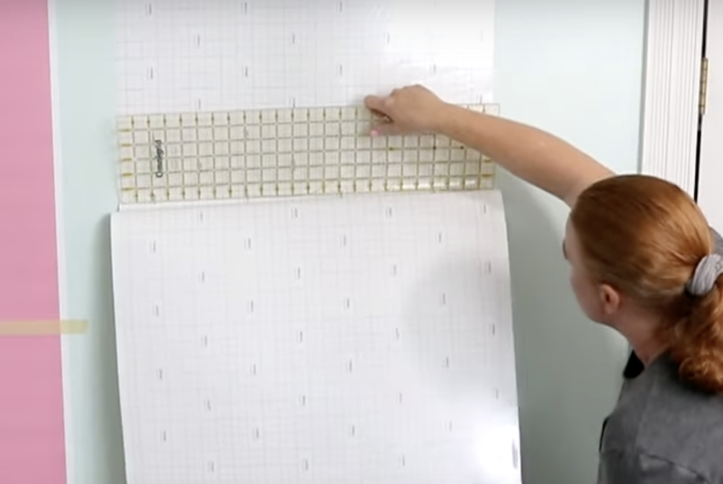 Use quilting ruler to smooth onto wall.