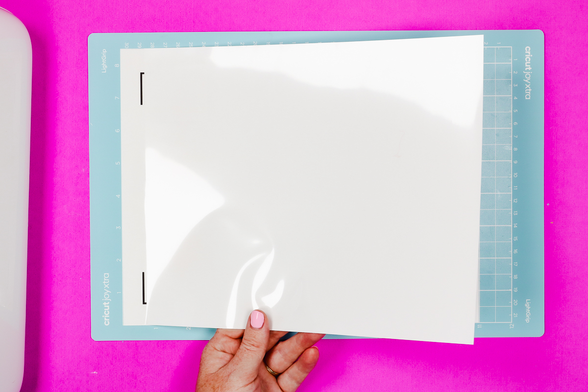 Align vinyl laminate to sticker sheet.