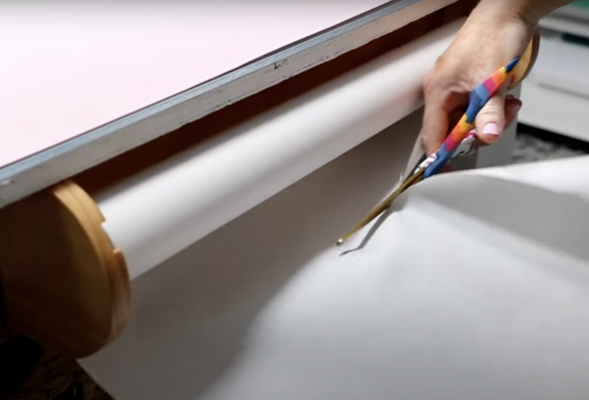 Use scissors to cut butcher paper from wooden roll holder.