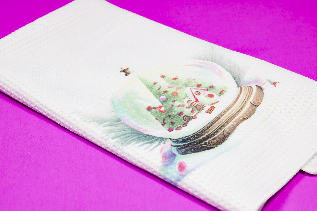 Sublimation kitchen towel with snow globe design.