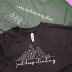 Finished Cricut Sweatshirts with design on chest and wrist.