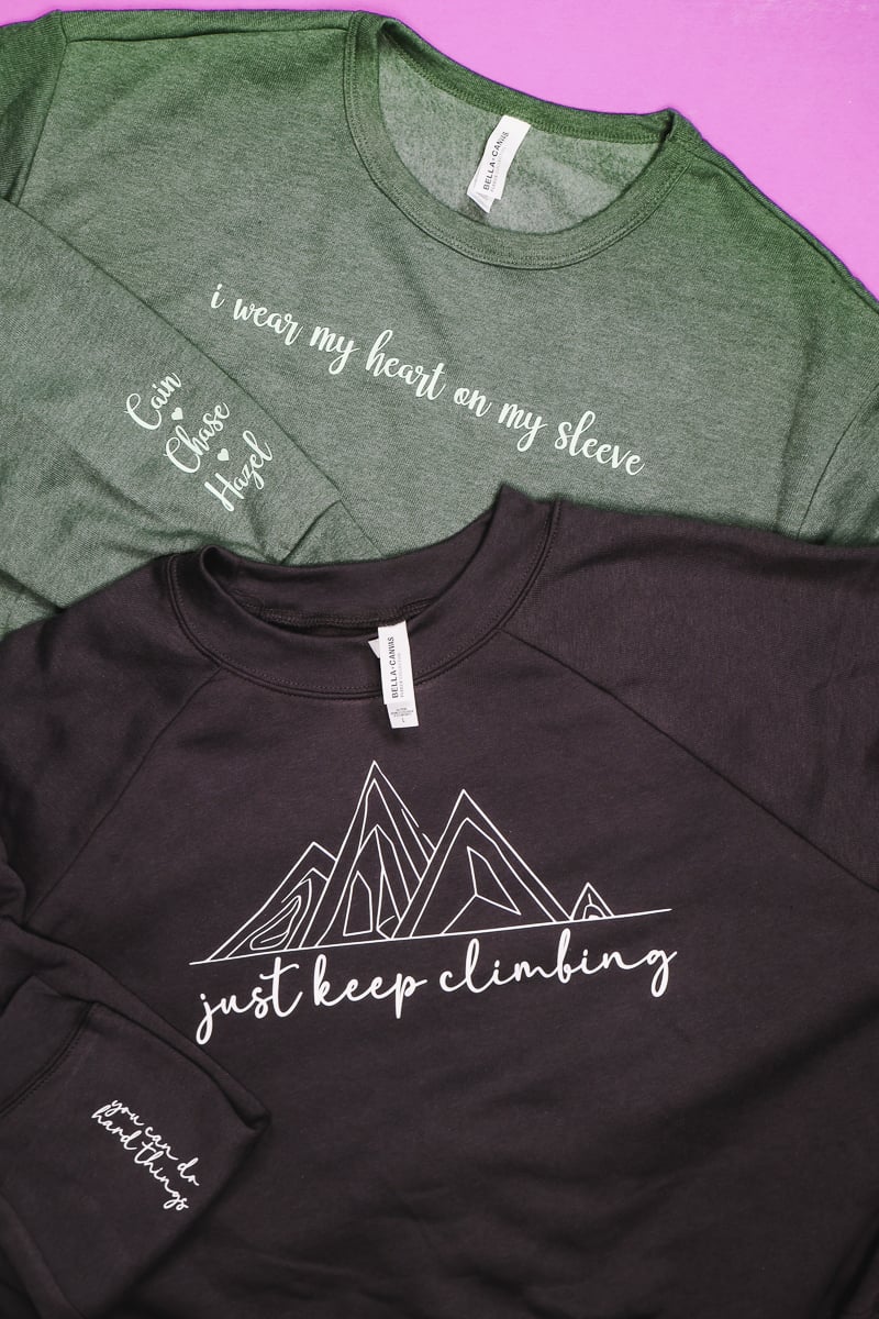 Finished Cricut Sweatshirts with design on chest and wrist.