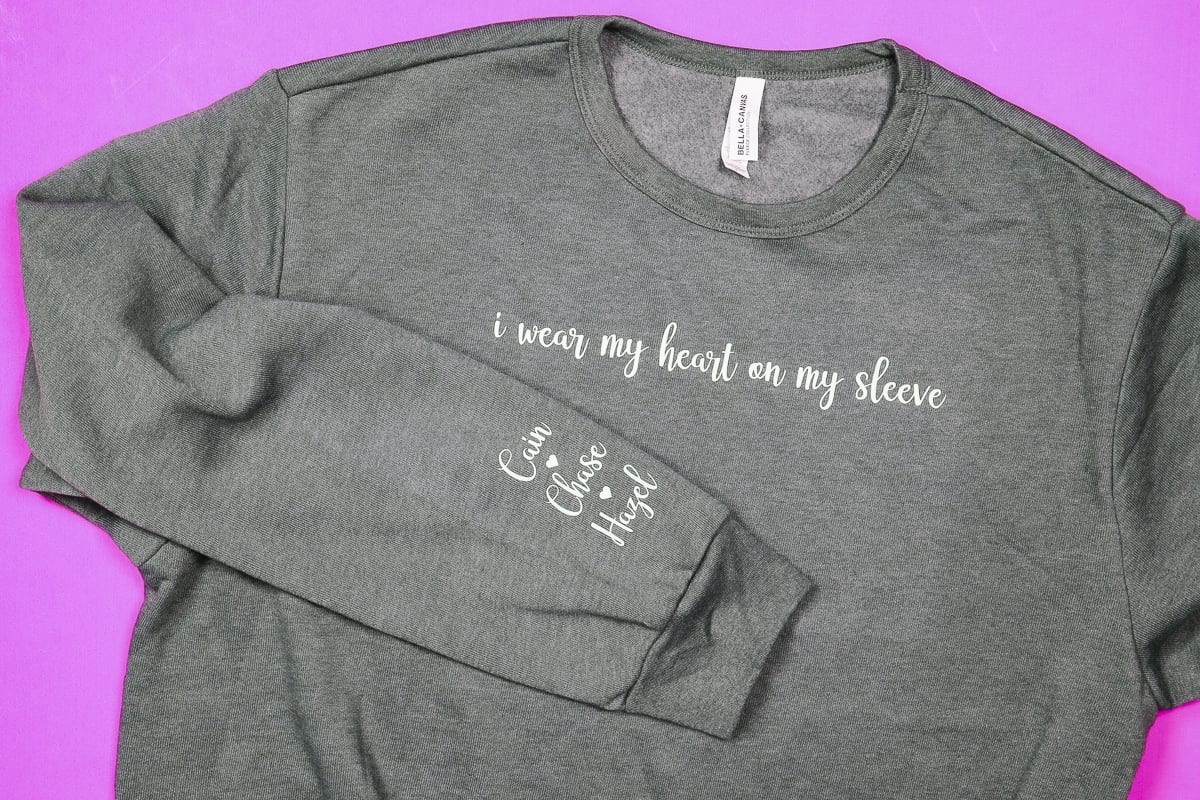 Close up of sweatshirt with Cricut designs on chest and wrist.