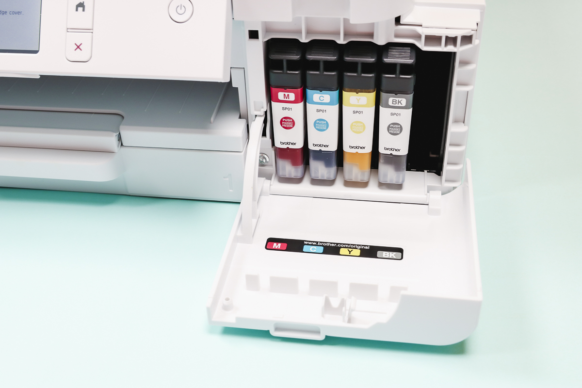 Installing ink cartridges into Brother sublimation printer.