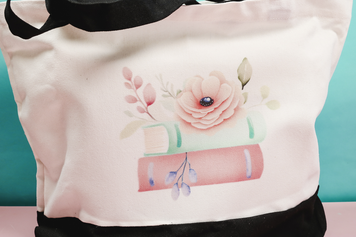 Floral book sublimation design on tote bag.