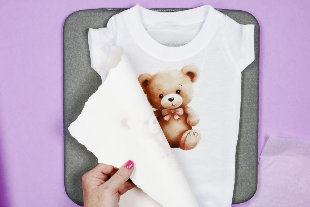 Remove protective paper and sublimation paper from onesie.