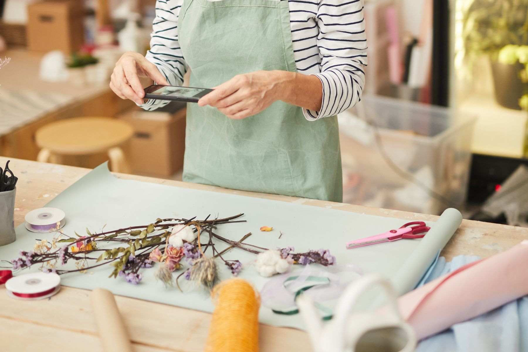 woman taking picture of crafts